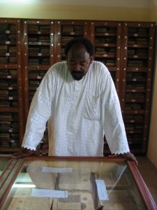 Abdelkader Haidara inspects ancient manuscripts in his Mamma Haidara Library in Timbuktu