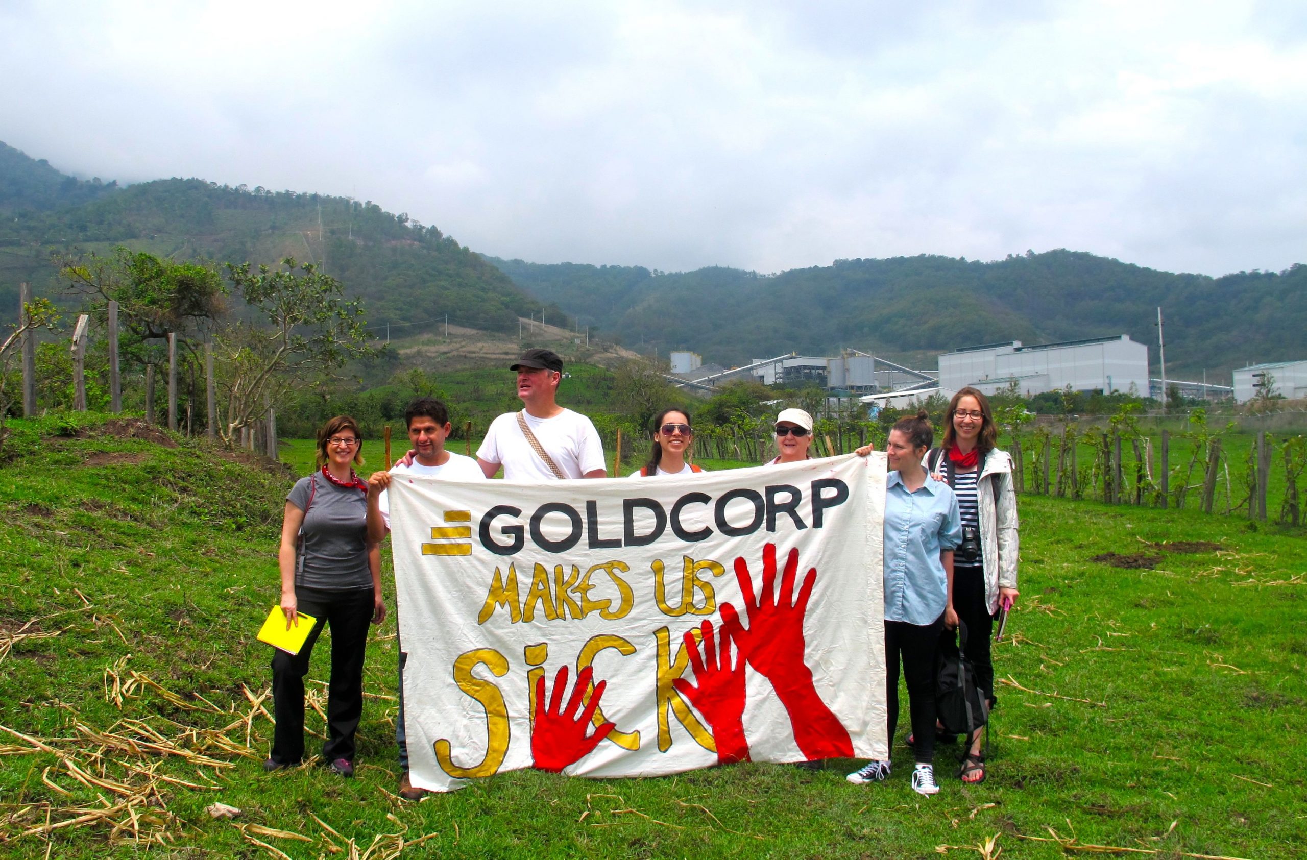 THis photo shows protestors holding a large banner saying "Goldcorp Makes Us Sick". Protesting Goldcorp in San Rafael las Flores, at the El Escobal Mine in Guatemala. This is the Canadian-owned Tahoe Resources El Escobal mine but Tahoe is a “child” of Goldcorp; former CEO of Goldcorp Kevin McArthur stepped down from Goldcorp and started Tahoe – of which Goldcorp owns some 40% of the shares. Photo: Catherine Nolin